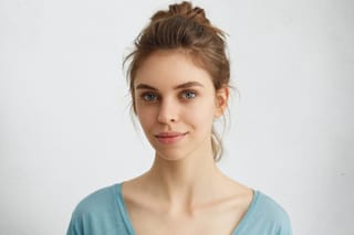 beautiful-female-with-lively-blue-eyes-well-shaped-lips-pure-skin-having-hair-bun-wearing-blue-casual-sweater-having-pleased-look-sensual-young-woman-with-appealing-face-looking.jpg